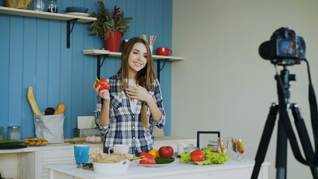 Young woman filming a cooking video in a kitchen